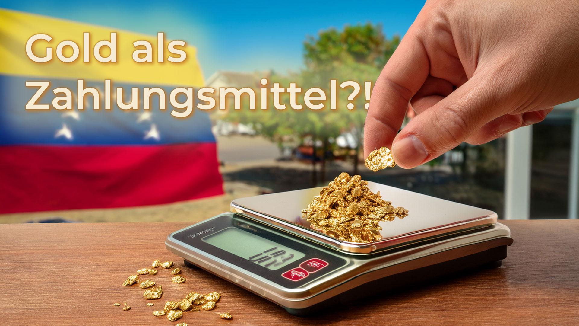 Kleine Goldflocken in einer Hand vor einem venezolanischen Strassencafé – Symbol für Gold als Zahlungsmittel